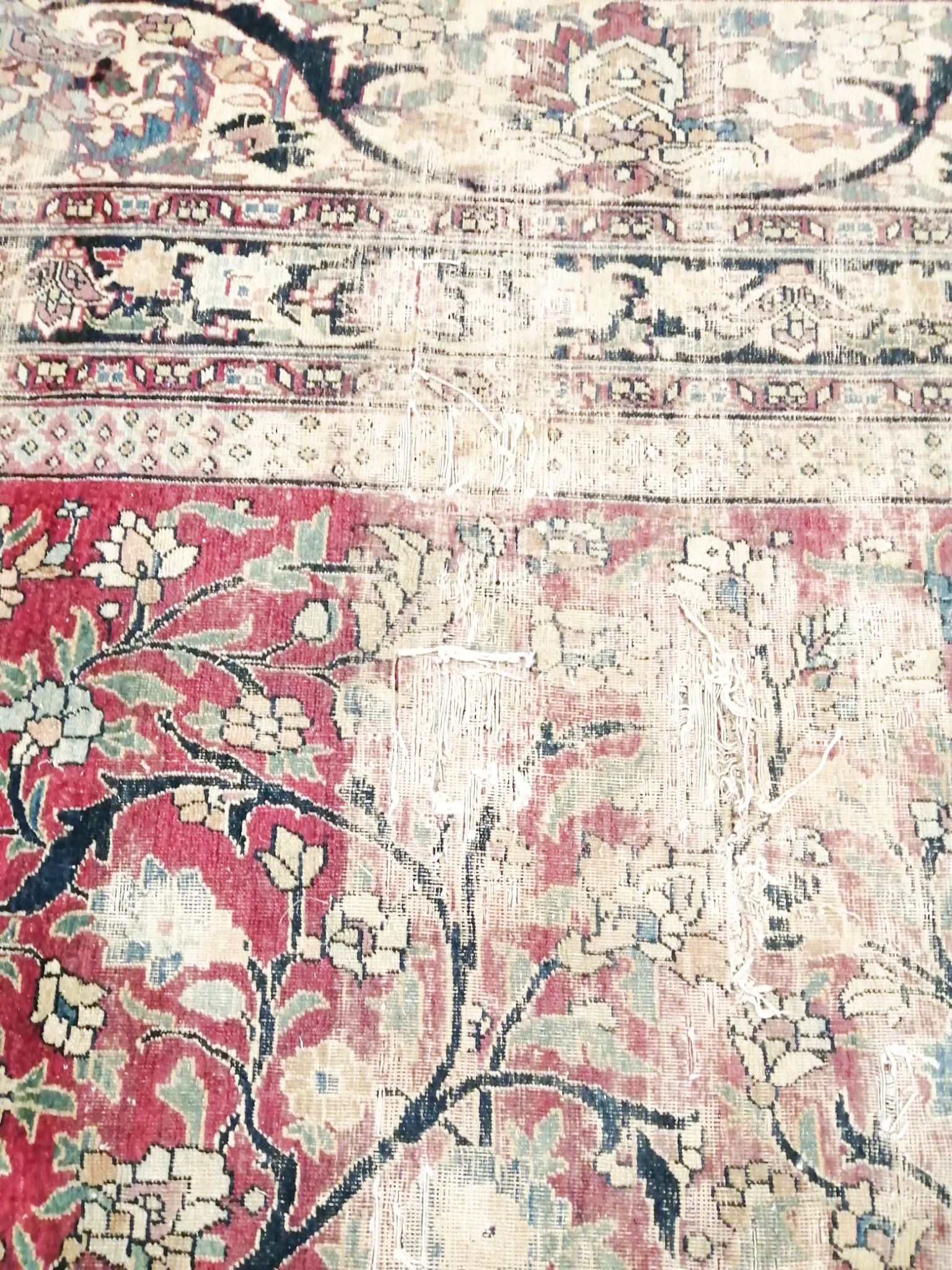 An antique Kashan blue ground carpet (worn and holed) 410 x 300cm